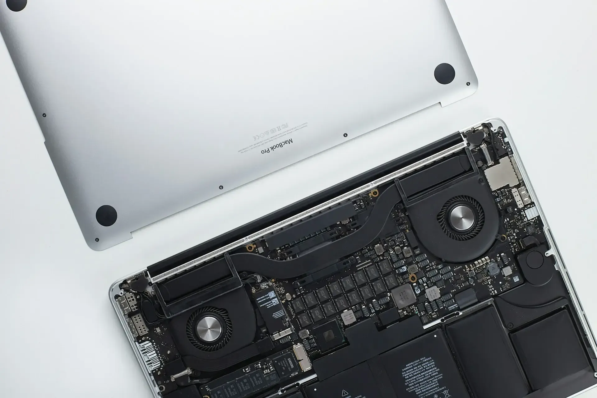 Macbook with back lid open and placed above laptop