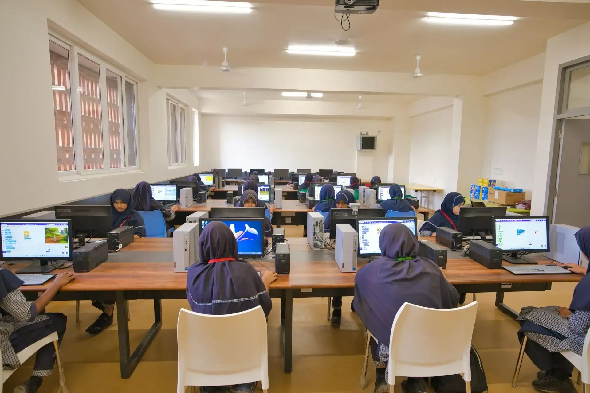 Students studying on computers on desks (1).webp