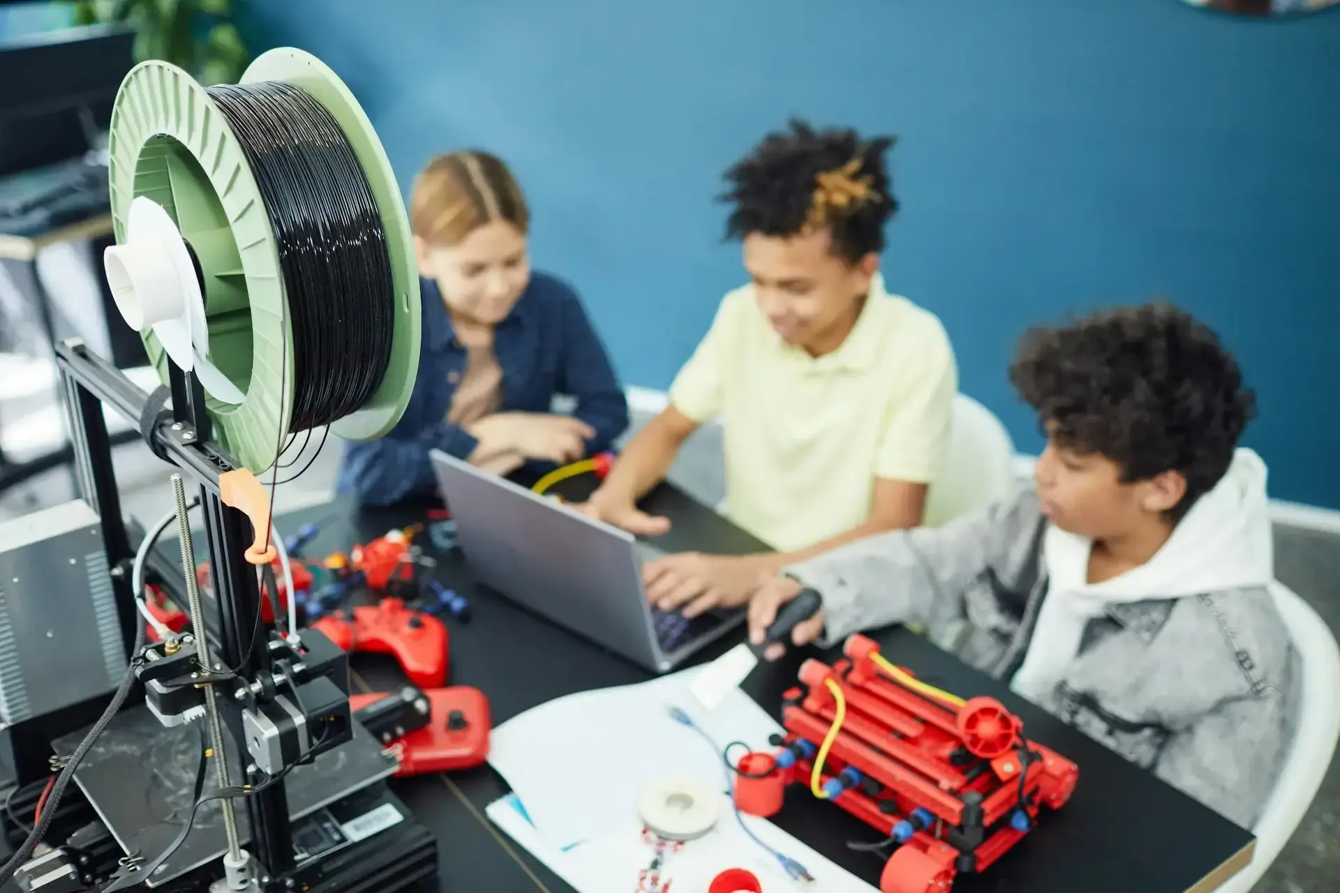 Three yound people working on robotics